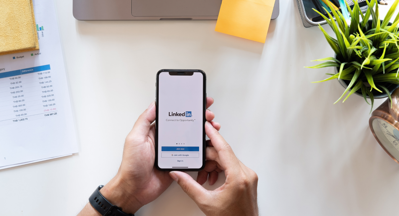 hands holding cellphone displaying linkedin