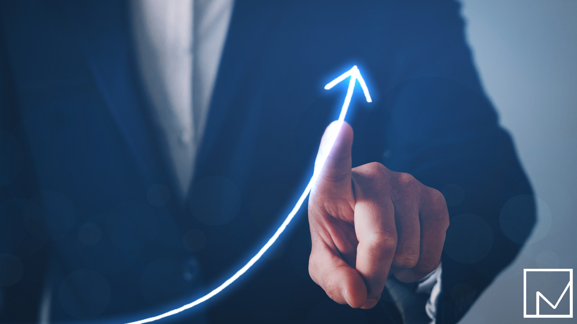 Businessman in suit pointing at an upward blue arrow symbolizing growth and success.
