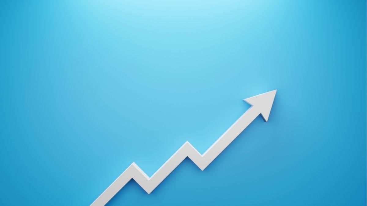 Upward trending arrow on blue background, representing how a specialty lender supports staffing firm growth and scalability.