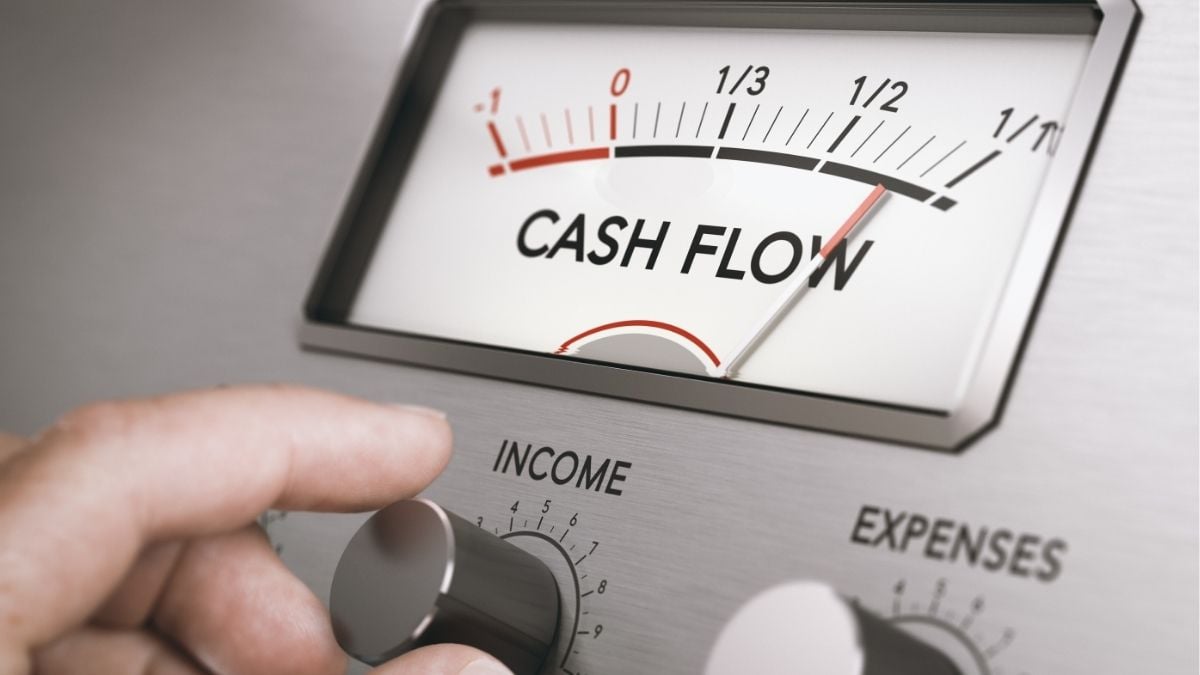 Cash flow gauge being adjusted, representing income, expenses, and improving cash flow management for business growth.