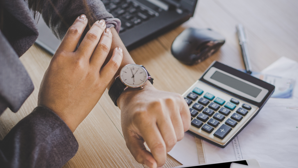 Staffing professional checking time on wristwatch, symbolizing time management and productivity.