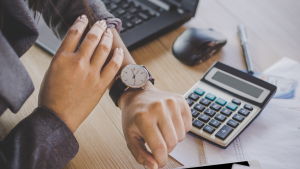 Staffing professional checking time on wristwatch, symbolizing time management and productivity.