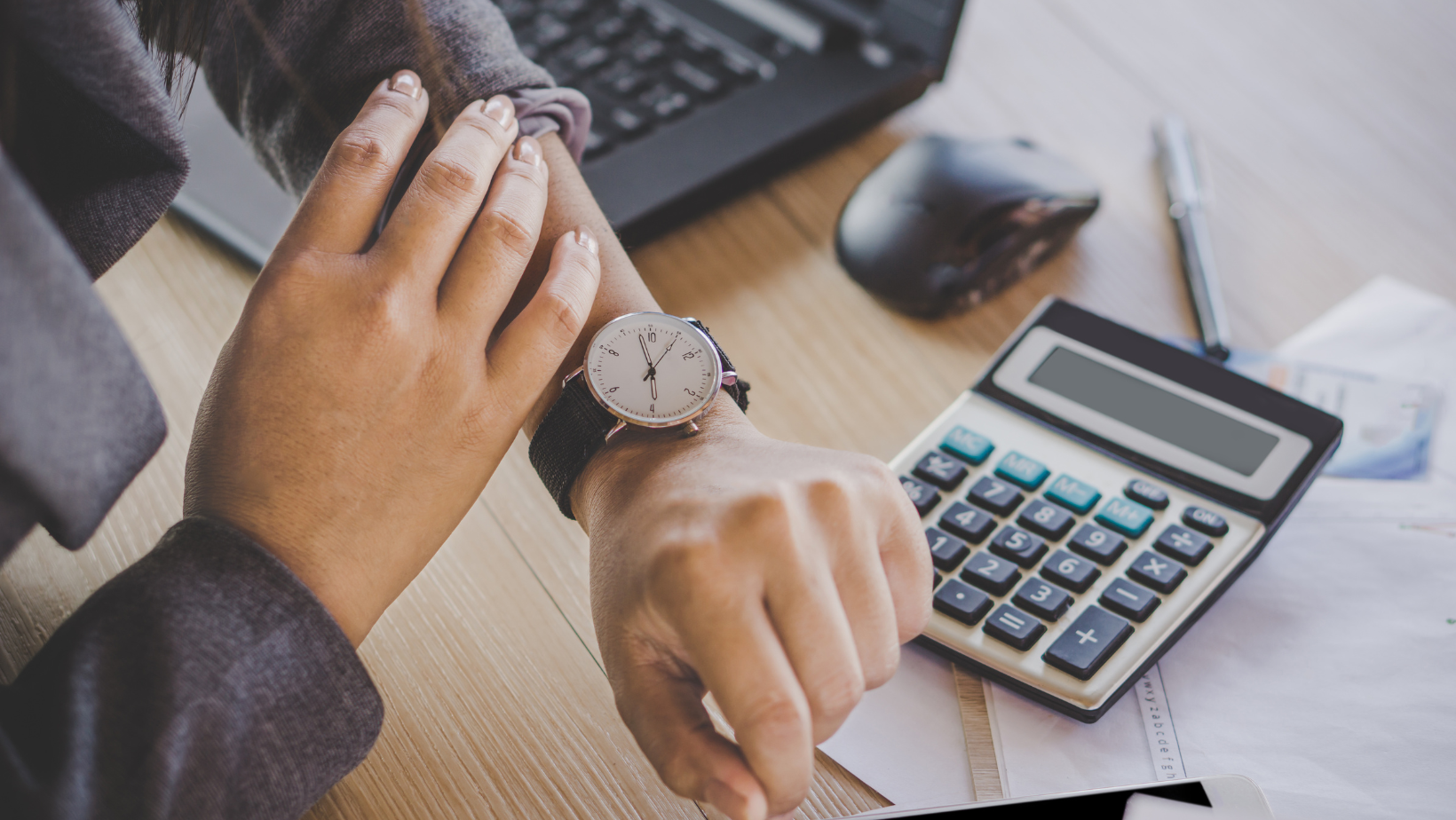Staffing professional checking time on wristwatch, symbolizing time management and productivity.