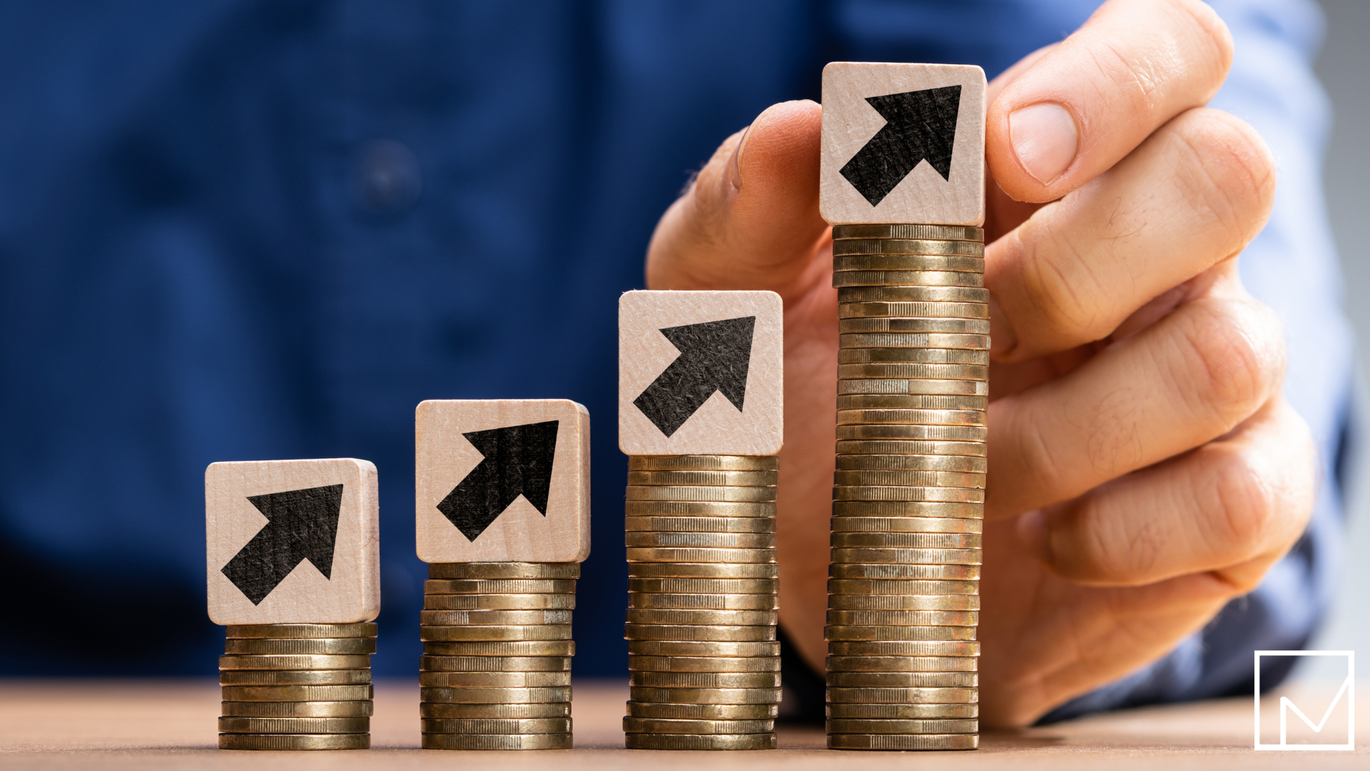 Man placing blocks upward on top of growing stacks of coins, symbolizing how contract staffing increases the value of a company.