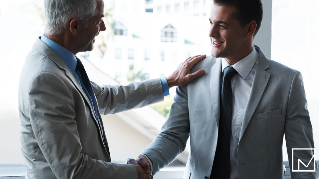 Two businessmen shaking hands, symbolizing the importance of relationships in the staffing industry.