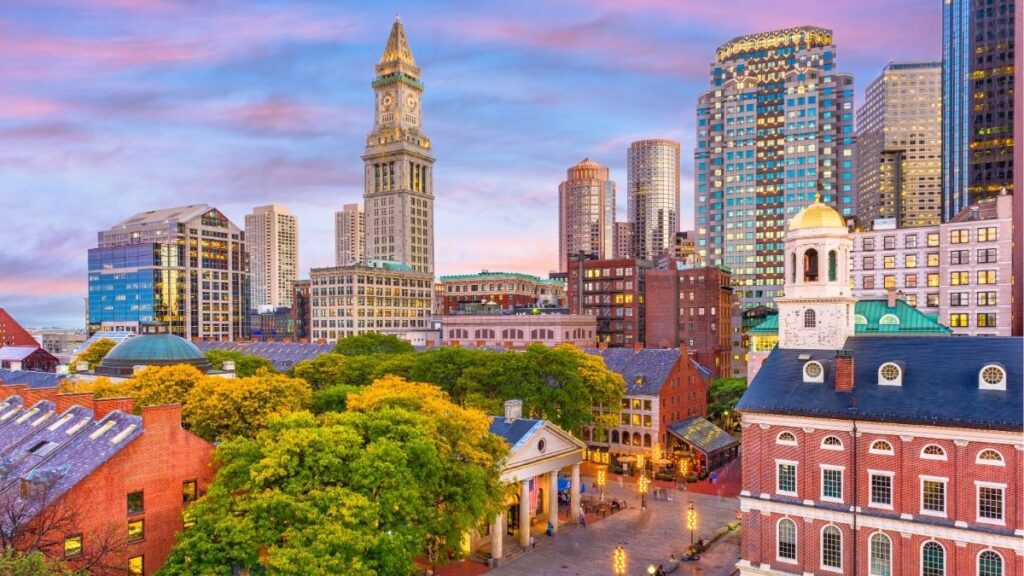 Boston skyline at sunset representing payroll funding and back office support for staffing firms in Boston.