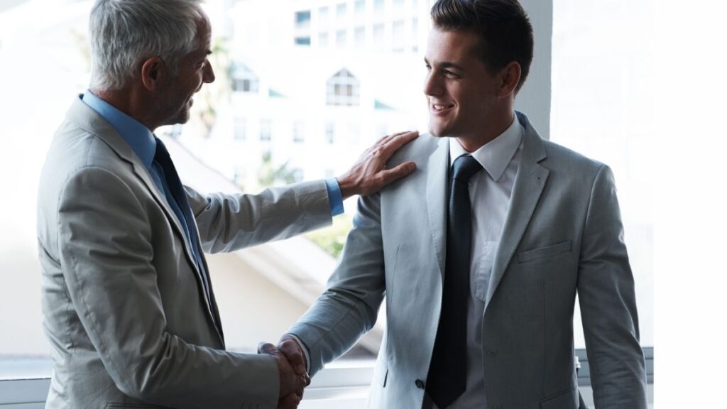 Two professionals shaking hands representing trust and strong relationships in staffing.
