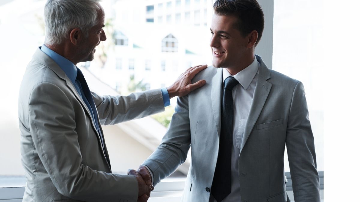 Two professionals shaking hands representing trust and strong relationships in staffing.