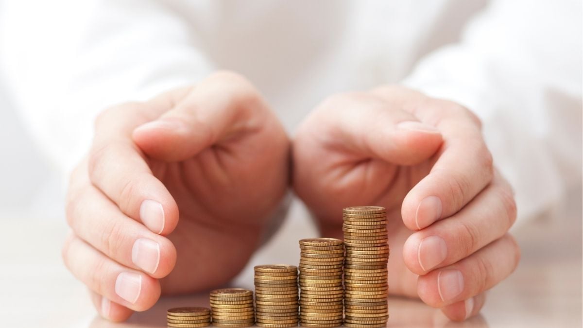Hands protecting growing stacks of coins representing cash flow advantage from invoice date vs receipt date in staffing.