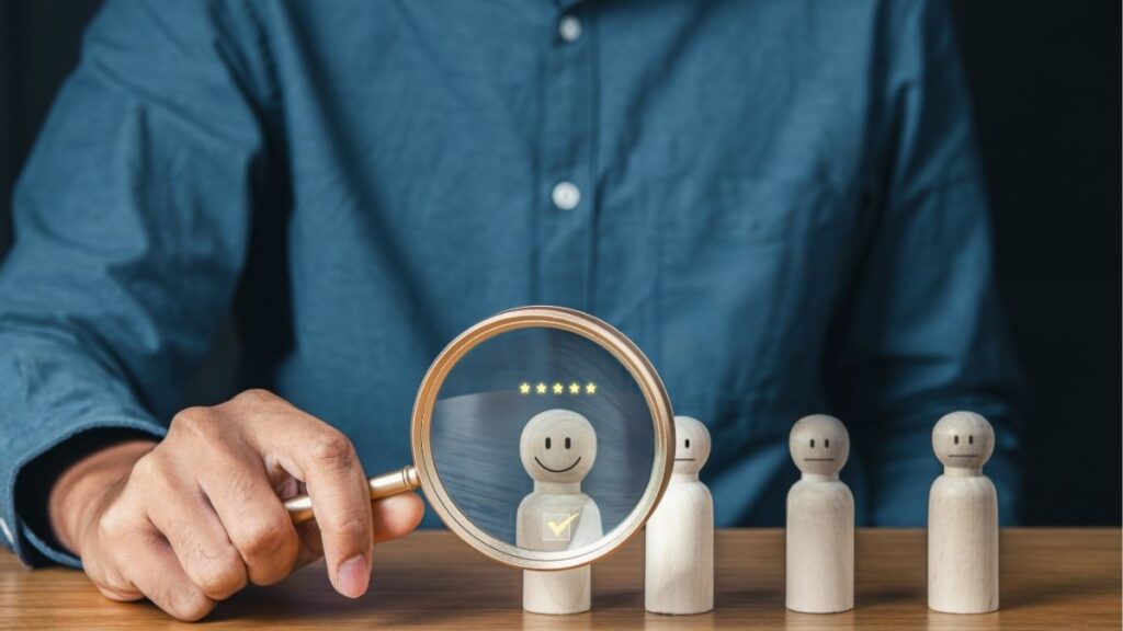 Small business owner evaluating candidates and selecting top employee using proven hiring strategies.