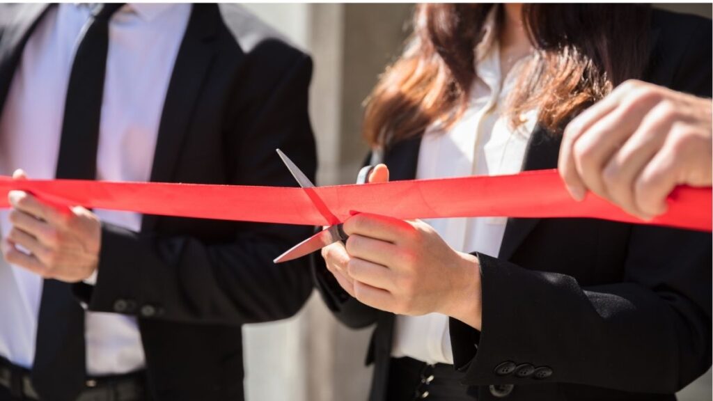 Cutting ribbon ceremony representing recruiters leaving staffing firms to start their own business.