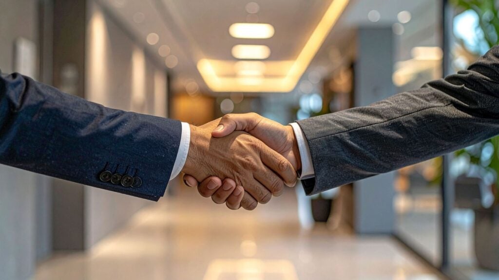 Business handshake representing the strong client relationships and specialized partnerships built by niche staffing firms.
