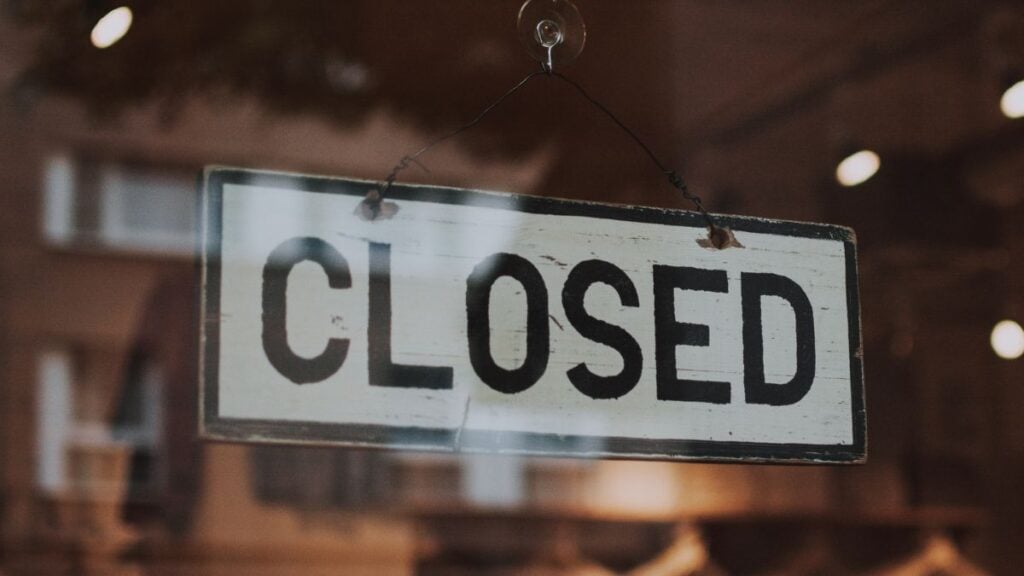 Closed sign on business door representing staffing firm closure and new market opportunity.