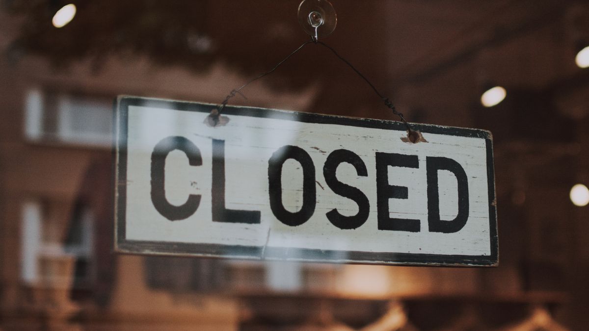 Closed sign on business door representing staffing firm closure and new market opportunity.