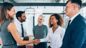 New staffing agency team meeting with clients to build business relationships in year one.
