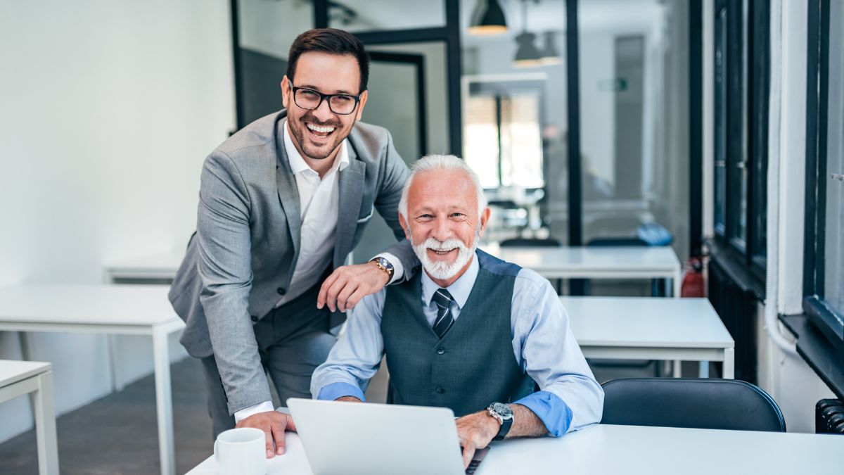 Family-run staffing firm leaders working together in office reviewing business operations.