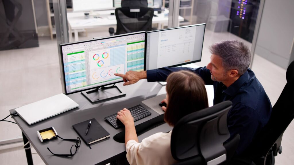 IT professionals reviewing data and reports on computer screens, representing diverse IT staffing roles and technology workforce solutions.