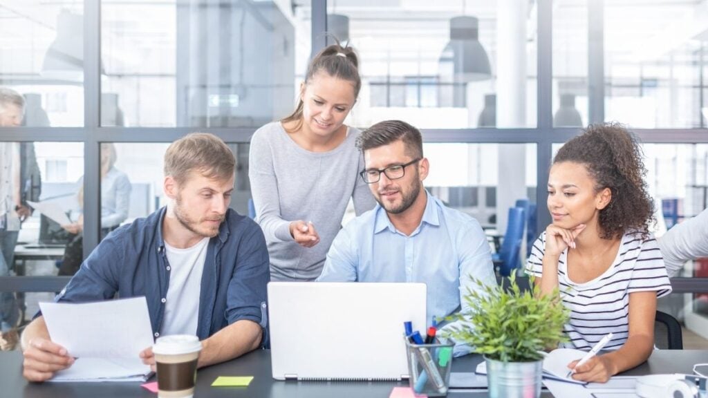 Team reviewing staffing firm payroll and operational data on a computer.