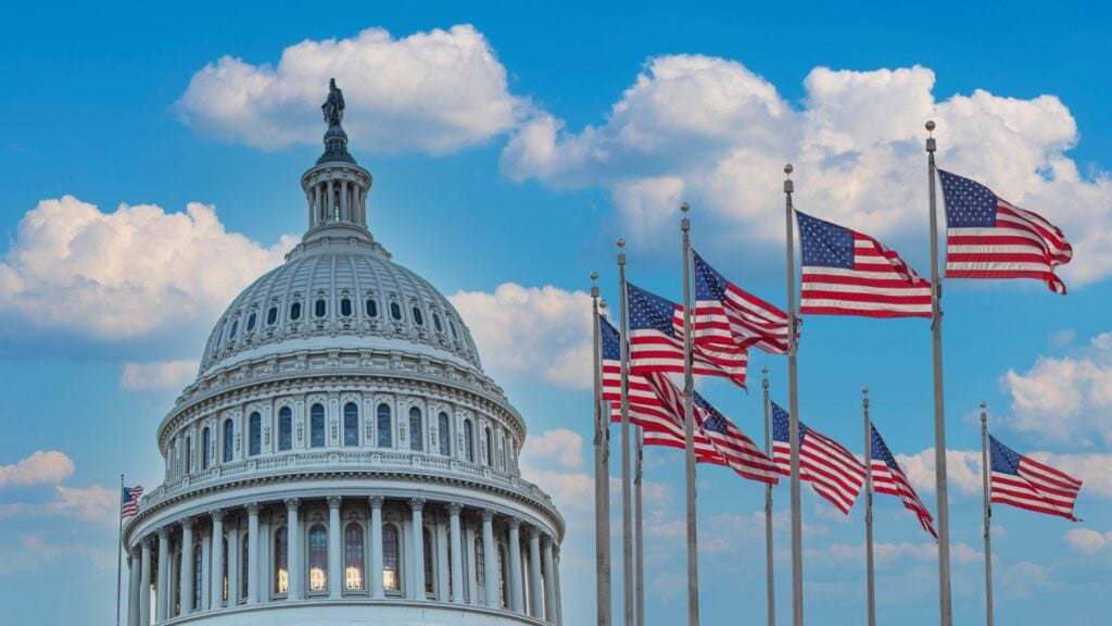 United States Capitol building with American flags, representing government contract staffing and payroll funding for public sector contracts.