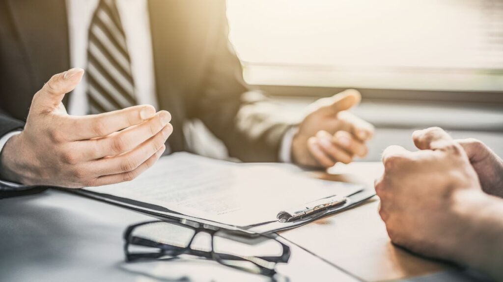 Two professionals reviewing documents together in a collaborative setting, representing strategic consulting and advisory support for healthcare staffing firms.