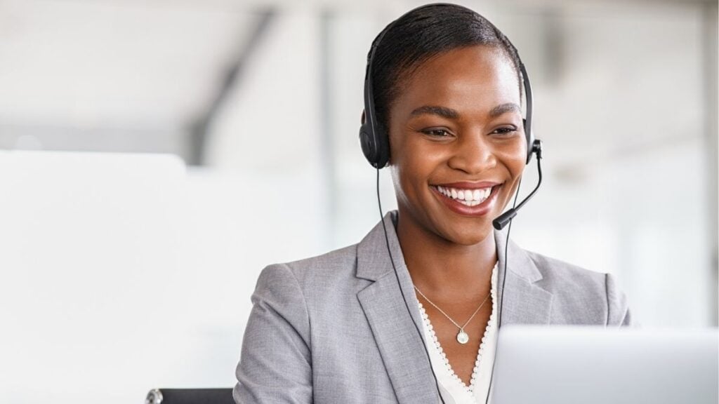 Professional communicating with clients via headset, representing staffing collections support and accounts receivable management.