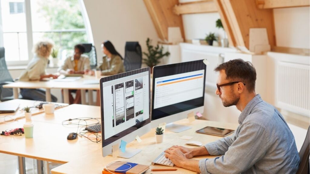 Staffing professional using software platform to manage operations, reporting, and workflow efficiency in a modern office.