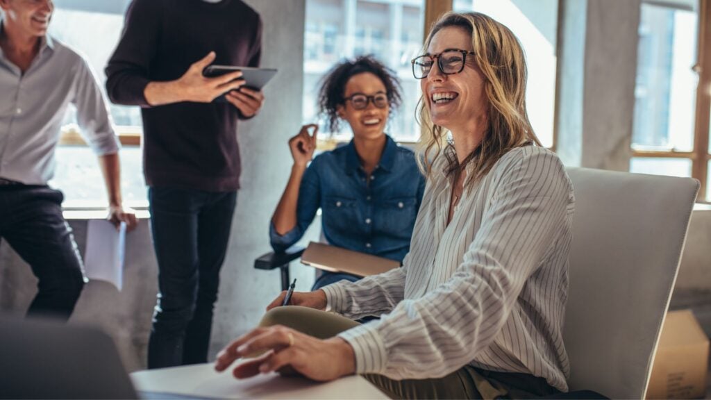 Team of staffing professionals collaborating in a modern office representing payroll funding solutions for growth-focused staffing firms.