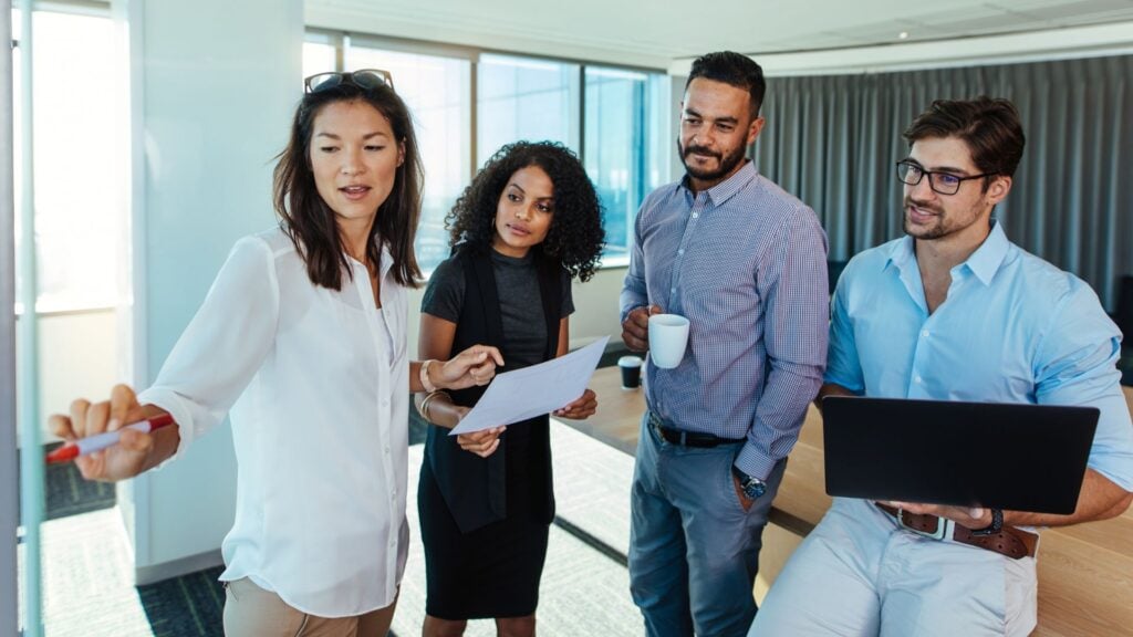 Staffing professionals collaborating in a modern office representing payroll funding and back office solutions for staffing firms nationwide.