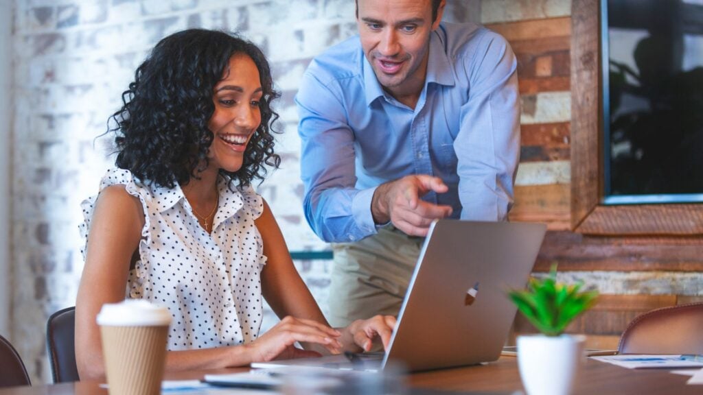 Startup staffing firm professionals reviewing business growth, recruiting operations, and payroll funding strategy during a collaborative office meeting.