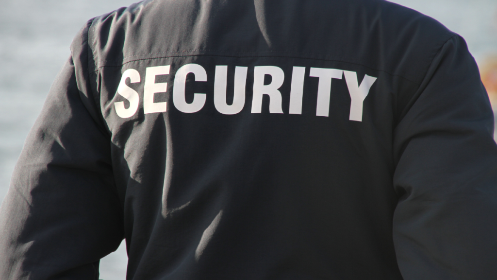 Security officer standing on duty, representing security staffing firms that use invoice factoring to improve cash flow and fund payroll.
