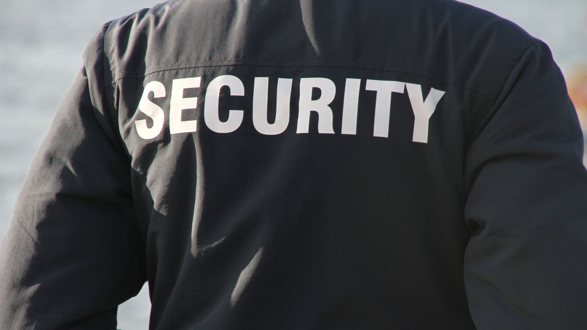 Security officer standing on duty, representing security staffing firms that use invoice factoring to improve cash flow and fund payroll.