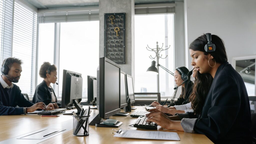 Staffing professionals working together in an office to improve staffing operational efficiency through recruiting, communication, and back-office collaboration.