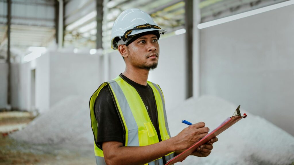 Industrial worker at a manufacturing facility representing low-skilled staffing and workforce turnover.