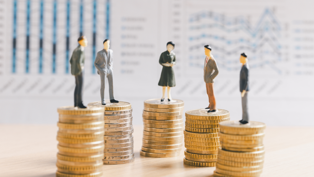 Business professionals standing on stacks of coins representing accounts receivable diversification and reducing customer concentration risk for staffing firms.