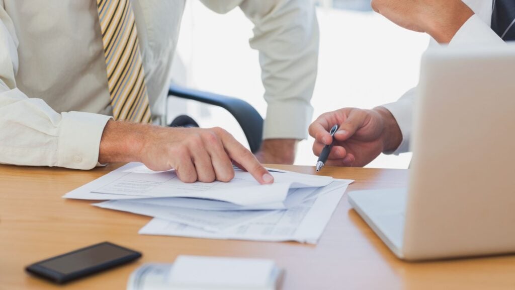 staffing agency startup cost planning - Madison Resources - Madison Resources Business professionals reviewing startup costs and financial planning documents for a new staffing agency.