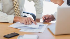 staffing agency startup cost planning - Madison Resources - Madison Resources Business professionals reviewing startup costs and financial planning documents for a new staffing agency.