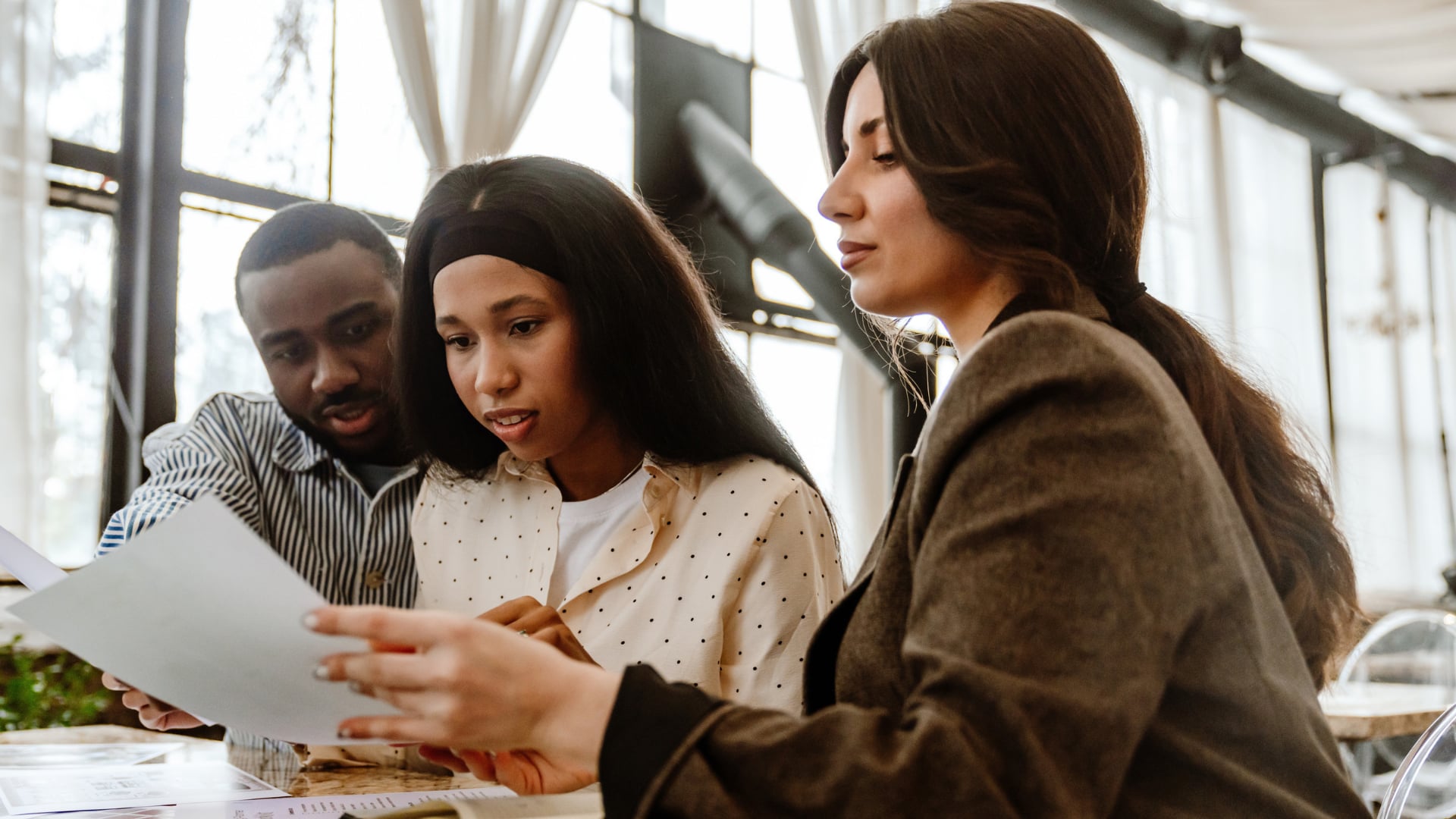 staffing agency team reviewing staffing agency cash flow and invoice paperwork together - Madison Resources - Madison Resources Staffing company reviewing staffing agency cash flow